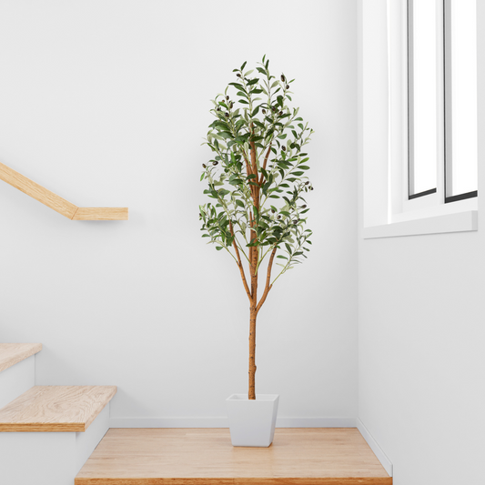 Kunstpflanze Olivenbaum "Negra" in stilvollem Wohnzimmer platziert
